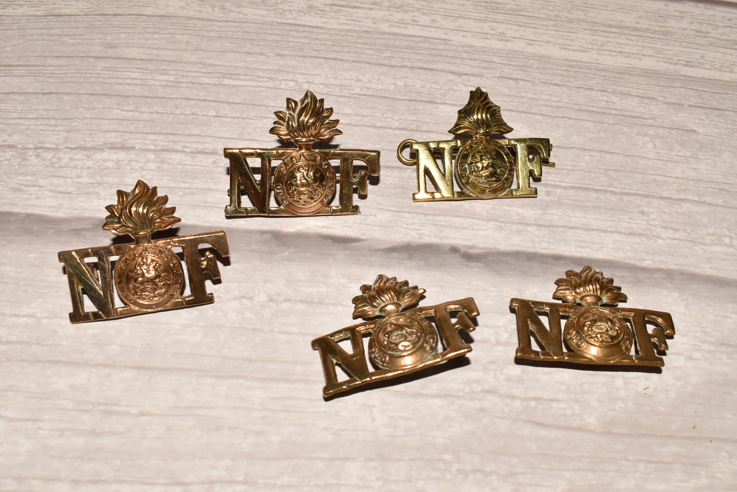 WW1 Northumberland Fusiliers Shoulder Title Badges - Original Brass Collection