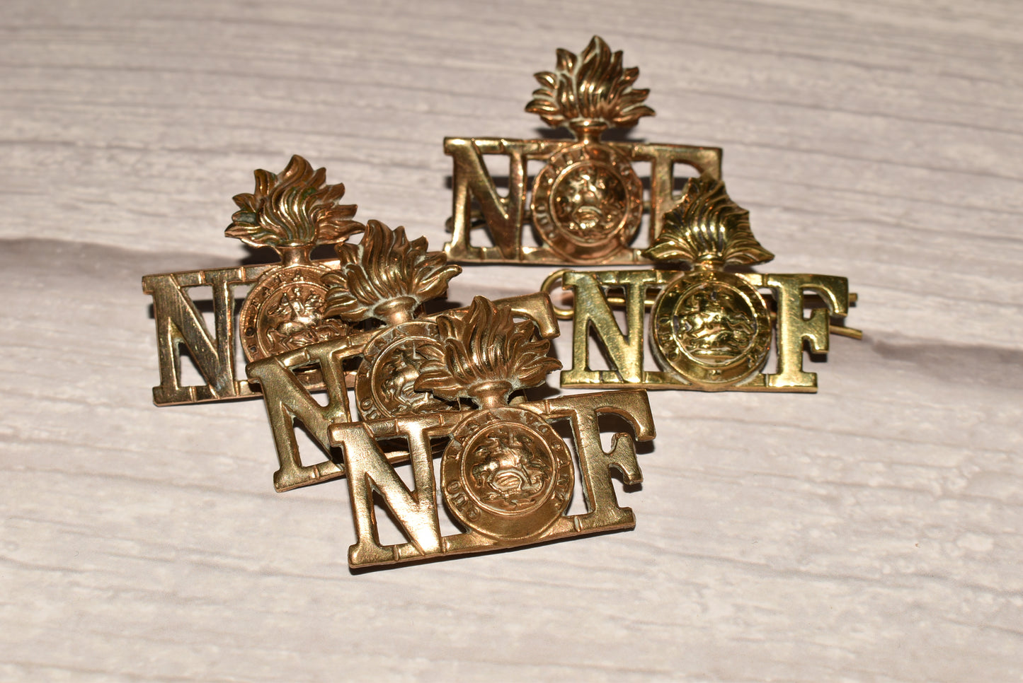 WW1 Northumberland Fusiliers Shoulder Title Badges - Original Brass Collection