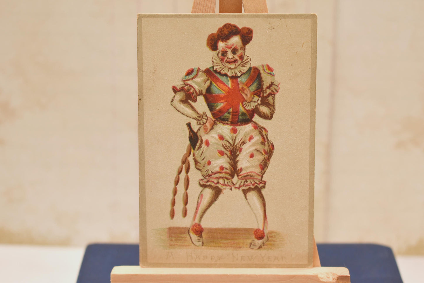 Antique Victorian New Year Card - Wonderful Macabre Scary Clown Stealing Drink and Sausages